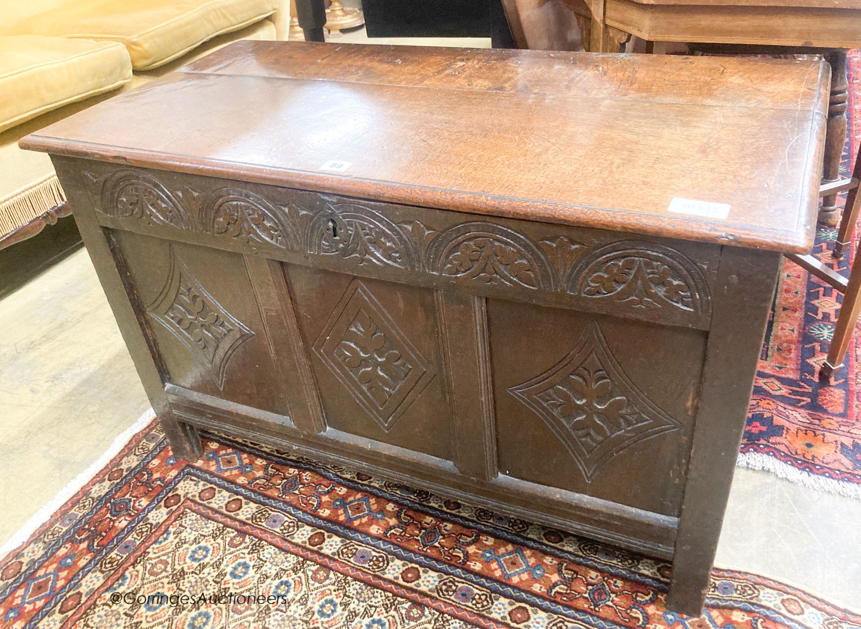 An 18th century carved oak coffer, length 95cm, depth 47cm, height 59cm